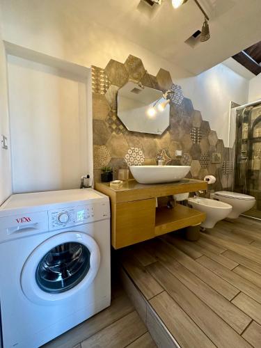 a bathroom with a washing machine and a sink at Balconi Bellavista in Cefalù