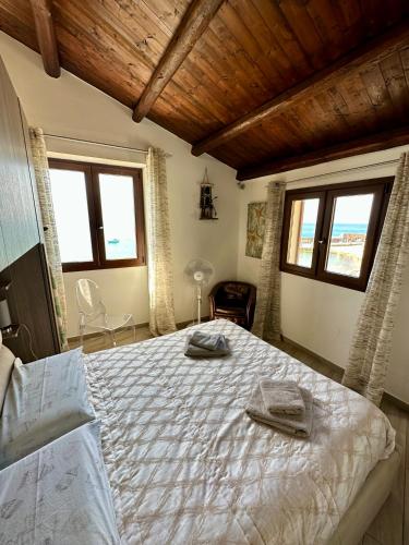 a bedroom with a bed with two towels on it at Balconi Bellavista in Cefalù
