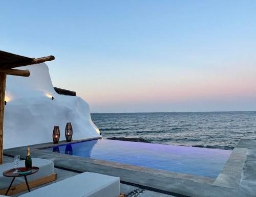 a view of the ocean from a house with a pool at Casa di Mare Luxury Villas in Imerovigli