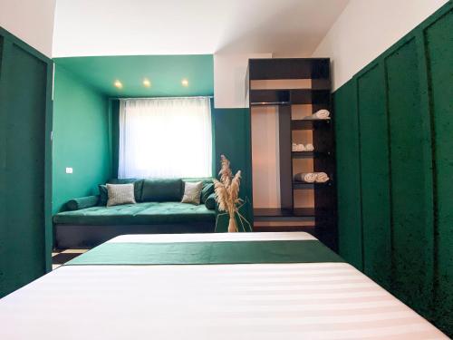a bedroom with a large bed and a couch at PROMO Elegant Apartments NEW - Colorful by the sea in Durrës