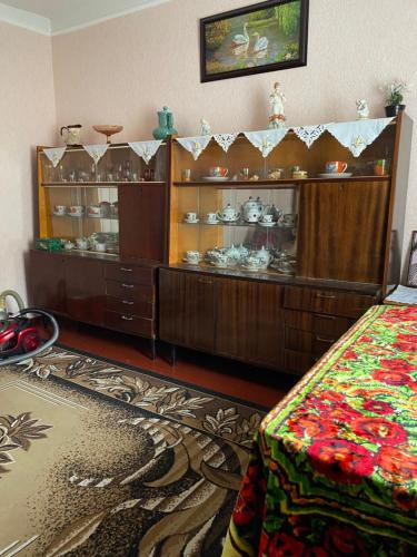 una habitación con un armario con platos. en Заміський будинок, en Rzhyshchiv