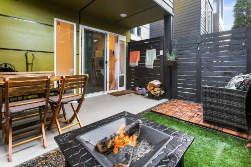 a patio with a fire pit and a table and bench at Modern Sustainable Design in Ballard - 92 Wlkscore in Seattle