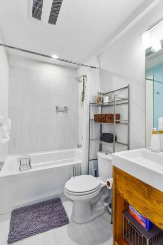 a bathroom with a toilet and a tub and a sink at Modern Sustainable Design in Ballard - 92 Wlkscore in Seattle