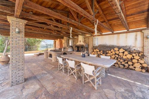 a dining room with a table and a pile of logs at Gustav Retreat Villa in Goumaíika
