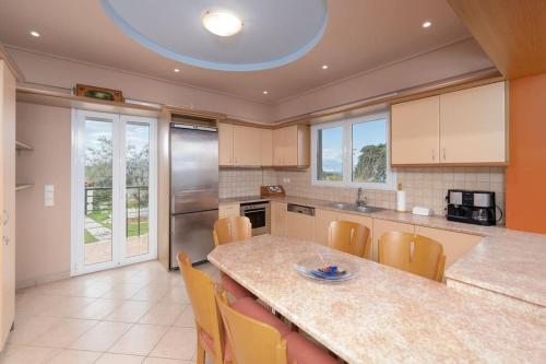 a kitchen with a table and chairs in a kitchen at Gustav Retreat Villa in Goumaíika
