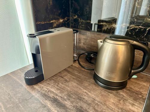 a coffee maker and a tea kettle on a counter at Magic Place Bergamo! Classy Apartment in the heart of the city in Bergamo