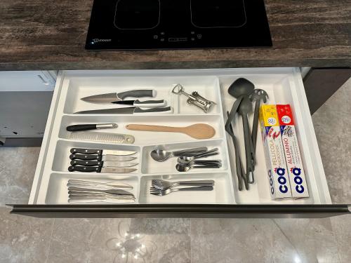 a white tray filled with utensils on a counter at Magic Place Bergamo! Appartamento elegante nel cuore di Bergamo in Bergamo