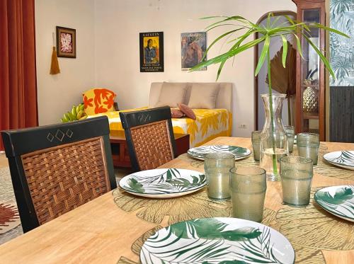 a dining room table with plates and dishes on it at Lagoon & Garden House w/ kayaks in Papara