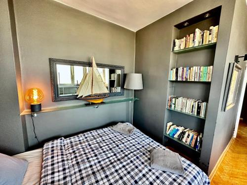 a bedroom with a bed and a sailboat on a shelf at Super Apartament GREY Centrum 2x Metro Fast WiFi 300 Mbs Netflix AppleTV SmartTV Spotify Panorama Miasta in Warsaw