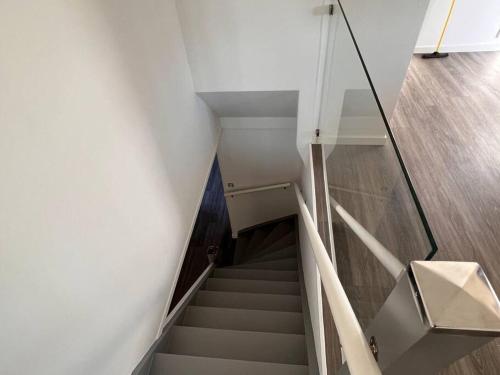 a staircase in a building with a glass wall at Lantlig villa i Ljungbyhed in Ljungbyhed