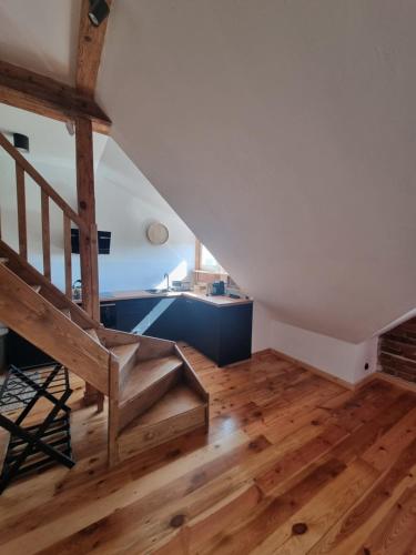 a staircase in a room with wooden floors and a stair case at Apartament Relax in Toruń