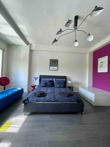 a bedroom with a large bed and a purple wall at Heart & Cherry Residency in Budapest