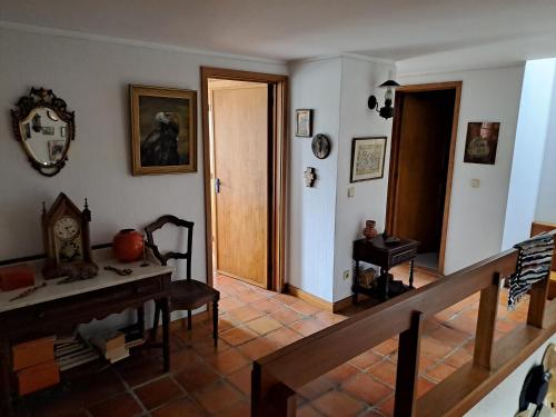 a living room with a staircase and a clock on the wall at Labruge Ocean View in Labruge