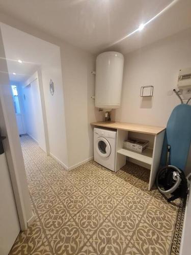 a laundry room with a washing machine and a washer at L'escale Charliendine in Charlieu