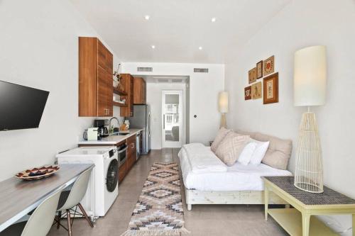 a living room with a white couch and a kitchen at Funky Pool Side Cabana in DTPHX in Phoenix