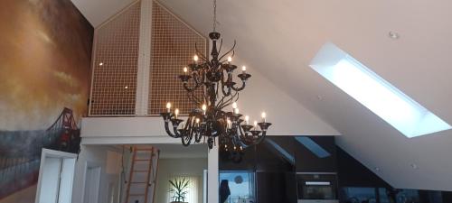 a chandelier hanging from a ceiling in a room at Loft la plus belle vue du lac Léman Montreux in Montreux