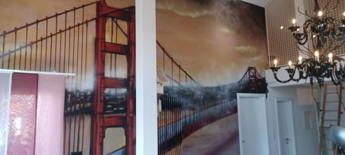 a room with a staircase and a painting on the wall at Loft la plus belle vue du lac Léman Montreux in Montreux