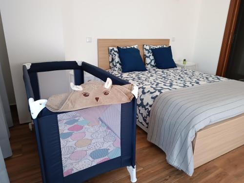 a bedroom with a bed with a blue frame at Casa Zeferino in Ferragudo