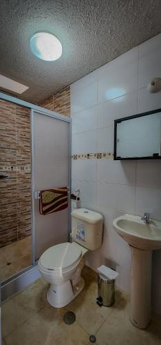 a bathroom with a toilet and a sink at Casa huerta Stuber in Arequipa
