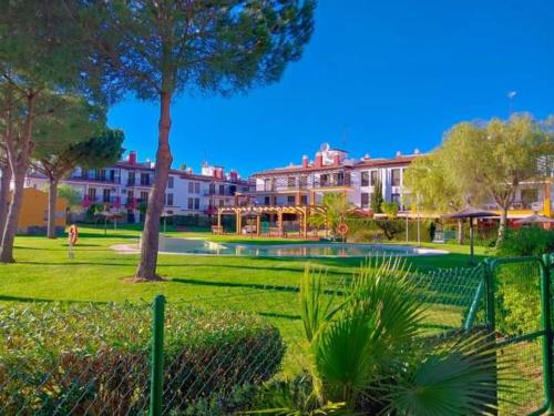 a park with a fence and trees and buildings at APARTAMENTO MANUELA RESIDENCIAL **VISTA ESURI** in Ayamonte
