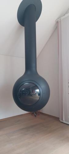 a black object is hanging from a wall at Loft la plus belle vue du lac Léman Montreux in Montreux