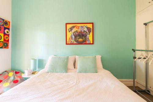 a bedroom with a bed with a picture of a dog at O'Briens of Clare - Stylish Pet Friendly Vineyard Accommodation in Clare