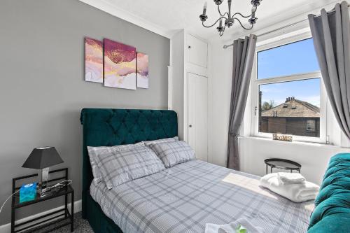 a bedroom with a bed and a window at Bella Casa two in Largs