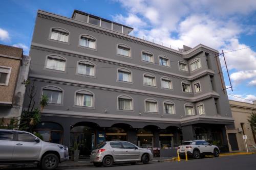 a large building with cars parked in front of it at Hotel Copahue in Junín