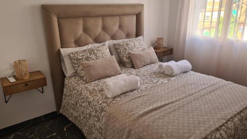 a bedroom with a large bed with towels on it at Albolafia junto Puente Romano in Córdoba