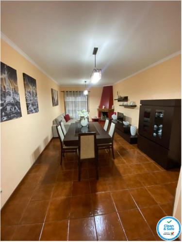 a living room with a dining room table and chairs at Oporto Cavadas House in Porto