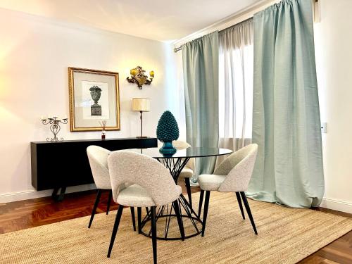 a dining room with a glass table and chairs at Taormina Casa Liliana in Taormina