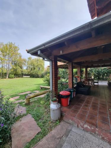a patio with a roof and some trash cans at Nagual B&B - Airport Shuttle in Tristán Suárez