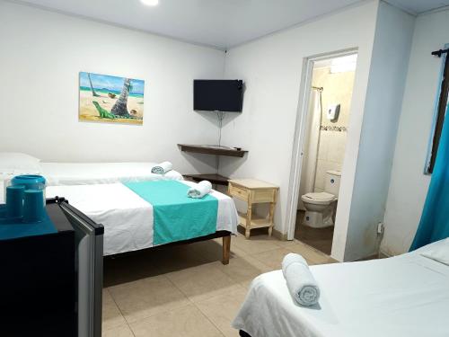 Ein Bett oder Betten in einem Zimmer der Unterkunft Posada Doña Rosa