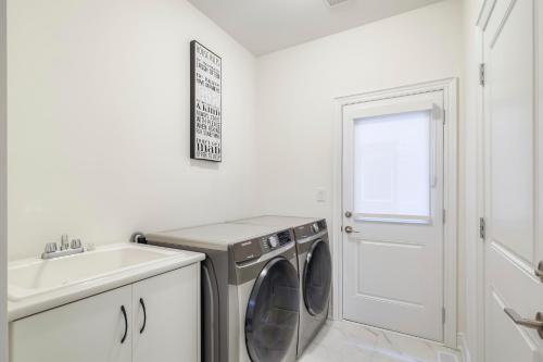a laundry room with a washing machine and a sink at Unwind Here in a Stylish and Cozy Space in Bradford