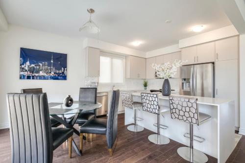 a kitchen and dining room with a table and chairs at Unwind Here in a Stylish and Cozy Space in Bradford