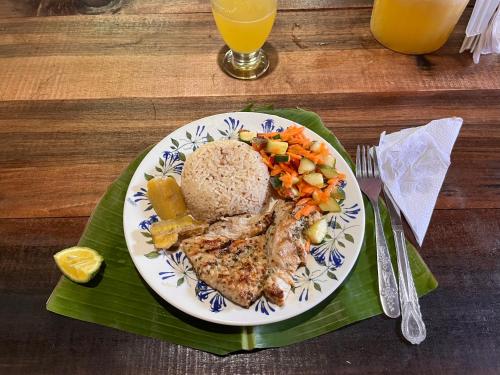 talerz żywności z ryżem i warzywami na stole w obiekcie Perla del cabo w mieście Arusí