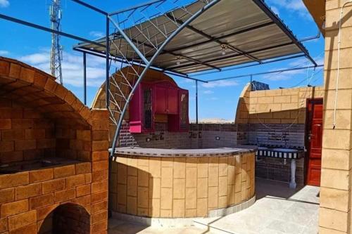 an outdoor kitchen in a brick building at Addas Home in Siwa