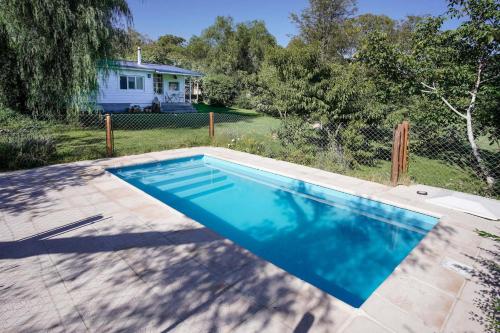 a swimming pool in front of a house at Chalet Las Doritas in La Cumbre