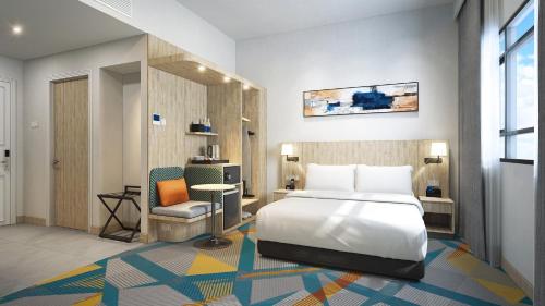 a hotel room with a bed and a chair at Holiday Inn Express & Suites Singapore Novena by IHG in Singapore