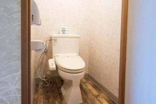 a bathroom with a white toilet in a stall at Blancart Misasa in Misasa