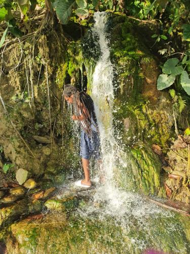 a person standing in front of a waterfall at Caribbean estate deluxe 2 in Portmore