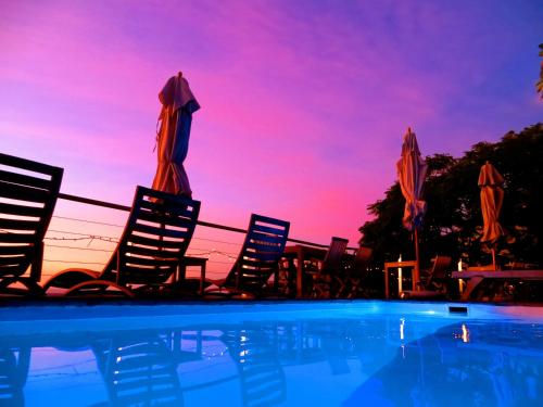 a group of chairs and umbrellas next to a swimming pool at Boutique@10 in Cape Town