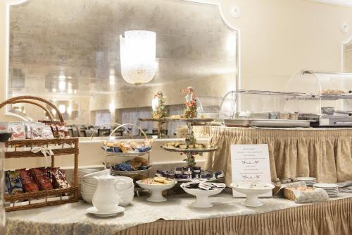 a buffet of food on a table in a kitchen at Hotel San Luca in Verona