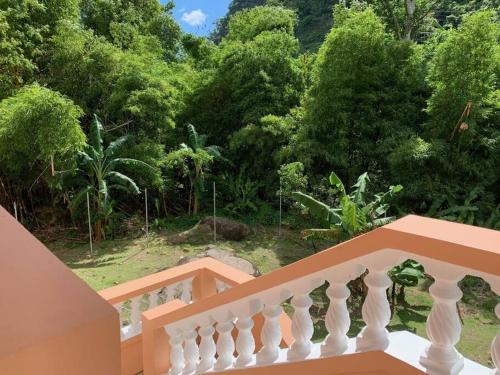 a balcony of a house with trees in the background at The Escape in Fond Cani