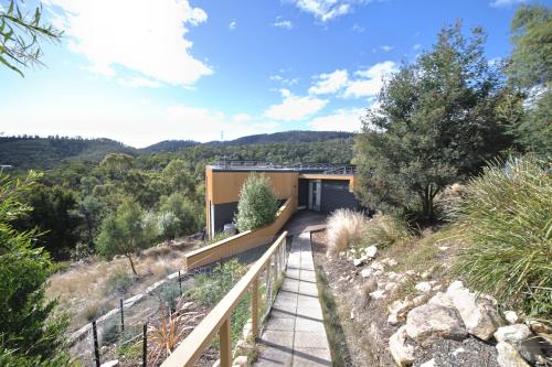 a house on a hill with a walkway at Luxurious, Tranquil and Private in Lindisfarne