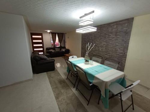 a dining room with a table and chairs in a living room at Luxos Casa Residencial Privada 