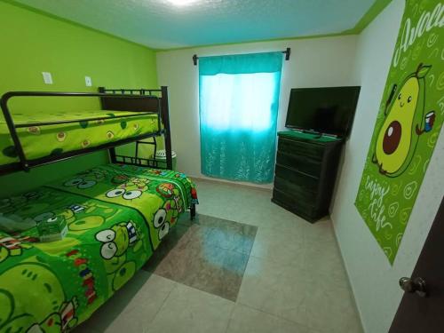 a bedroom with two bunk beds and a flat screen tv at Luxos Casa Residencial Privada 