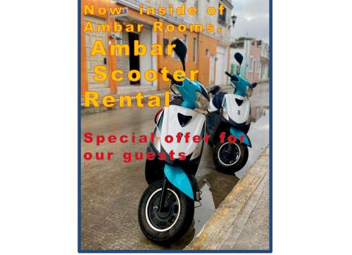 a couple of scooters parked on a street at AMBAR Rooms in Campeche