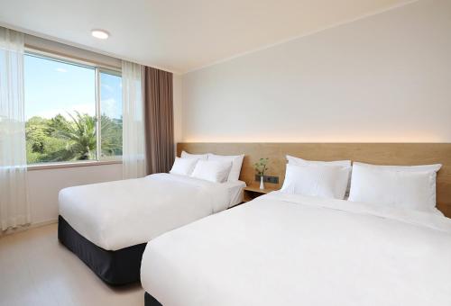 Ένα ή περισσότερα κρεβάτια σε δωμάτιο στο Bloom Hotel