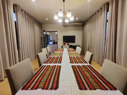 a long table with chairs and a long table at Bann White Chalet Khaoyai in Mu Si